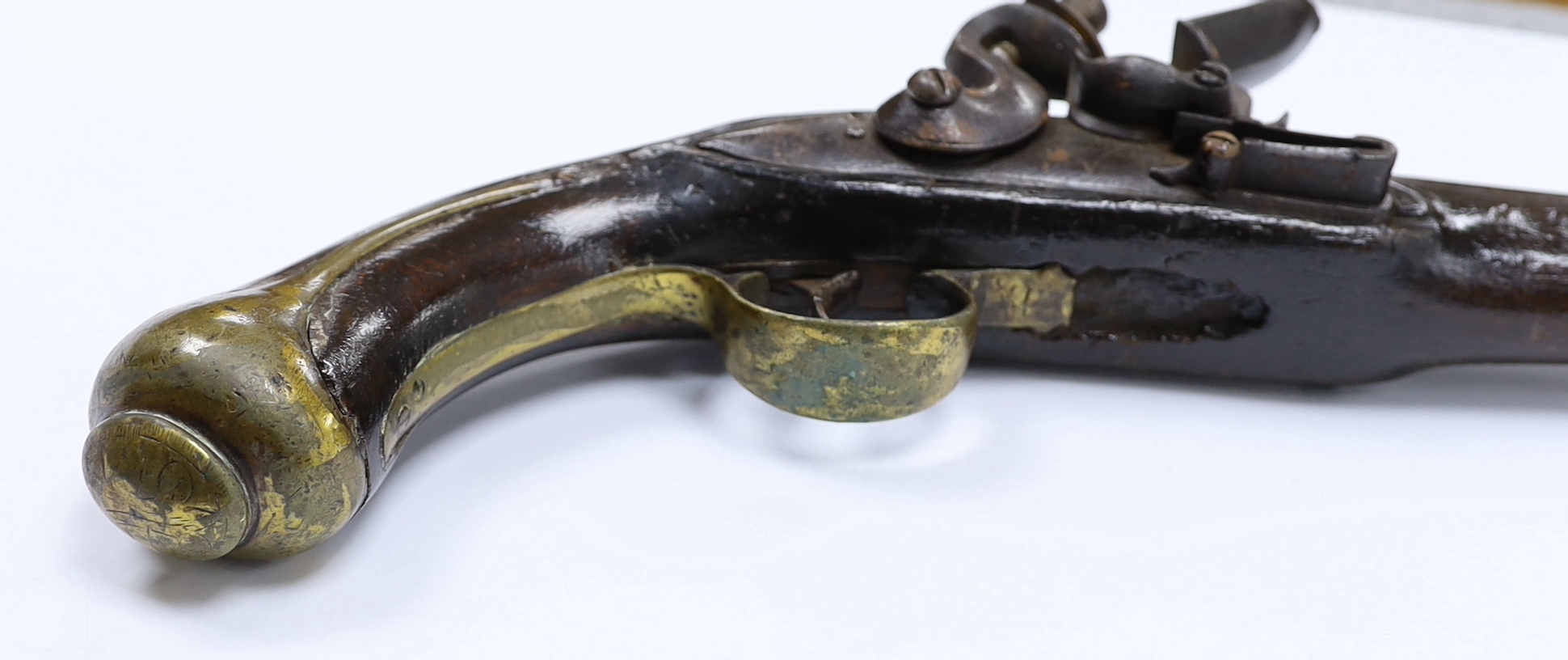 An early 19th century Balkan flintlock holster pistol. with limited engraving to lock and barrel and brass mounts (a.f.)